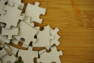 random jigsaw puzzle incomplete concept on wooden background. Copy space for text