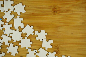 random jigsaw puzzle incomplete concept on wooden background. Copy space for text