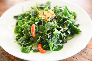 Stir fried oyster sauce watercress vegetable on white plate - Health food green vegetables cooked food in thailand