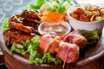 Meat dish of a restaurant with vegetbles and mayonaise