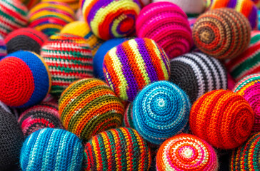 Fototapeta na wymiar Colorful fabric textile wool balls on the Andes craft market of Otavalo, north of Quito, Ecuador.