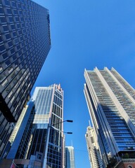 Fototapeta na wymiar Low Angle View Of Modern Buildings Against Clear Blue Sky