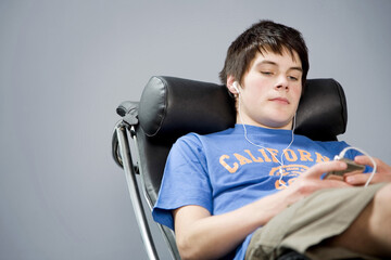 Boy listening to music on portable MP3 player