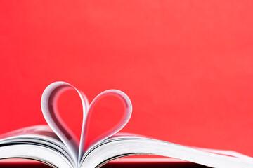 pages of a book curved into a heart shape