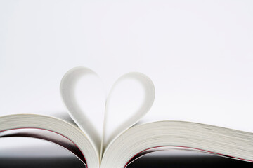 pages of a book curved into a heart shape