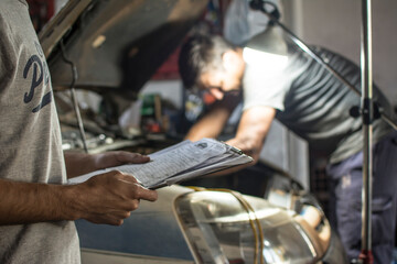 Mechanics working on a car engine