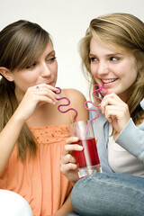 Girls sharing a glass of drink