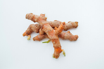 Close up fresh raw organic turmeric curcuma roots isolated on white background with clipping path