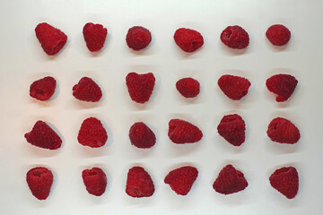 High angle view from directly above of 24 orderly arranged raspberries