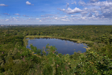 blue pond under sunny cloud sky