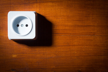 Electrical outlet on wooden wall