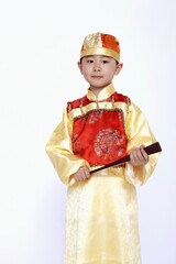 Fototapeta premium Boy in traditional costume with a hand-held fan