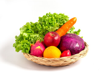 Group of fresh fruits and raw vagetables salad ingredients in basket on white background