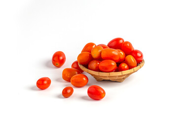 Red baby plum tomatoes in a basket isolated on white background.