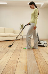 Fototapeta premium Woman vacuuming the floor