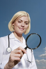 Woman holding magnifying glass