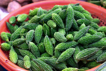 fresh green pile of bitter gourd melon in basket