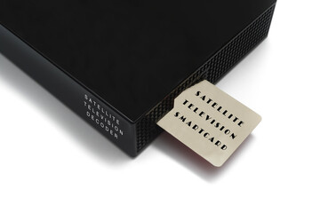 Isolated image of satellite television smart card inserting into the decoder over white background.