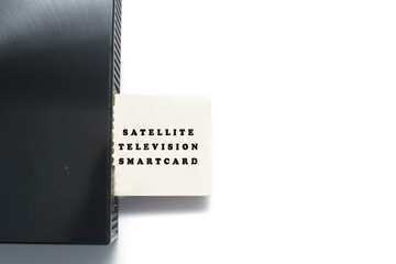 Isolated image of satellite television smart card inserting into the decoder over white background.