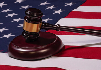 Low Angle Close Up of Gavel Standing Up on Sounding Block with United States Flag