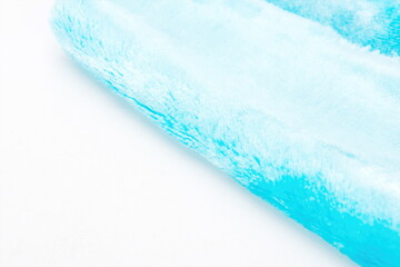 Close up of blue thickened towel in white background.