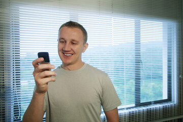 Man smiling while text messaging on the cell phone