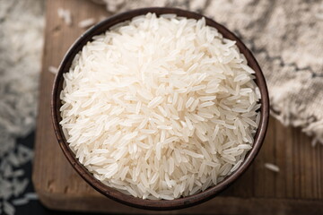 A large wooden bowl filled with Thai rice.