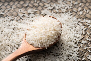 A wooden spoon for a pile of Thai rice.