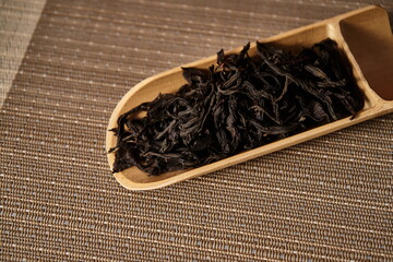A cut bamboo tube containing ancient black tea.