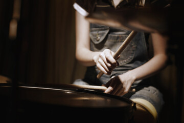 Young woman playing drums