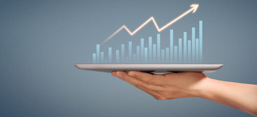 Graph growth and increase of chart positive indicators in his business, tablet in hand