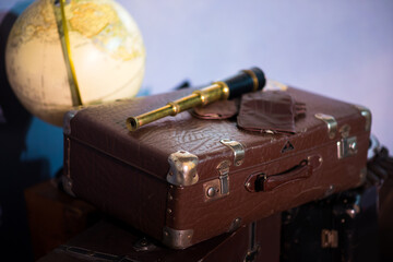 rustic suit case with vintage telescope