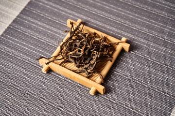 Tablecloth with boards holding dried black tea.