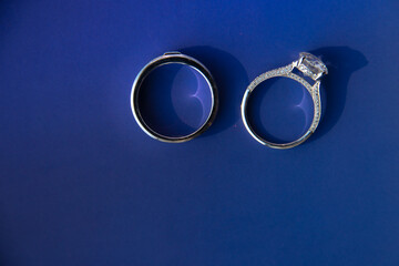 pair of couple wedding diamond ring on blue background