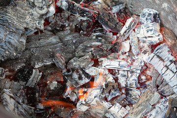 bright burning charcoal prepared for frying delicious barbecue, close-up photo.