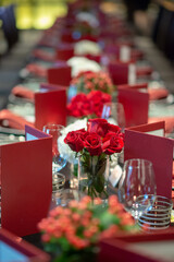Naklejka na ściany i meble bunch of red roses decorate on fine dining table