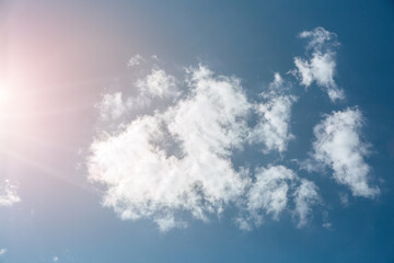Naklejka na ściany i meble Blue sky with white clouds and sun. Beautiful natural background. 