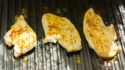 meat is fried on an electric grill.Steak meat grilled on barbecue.chicken with turmeric