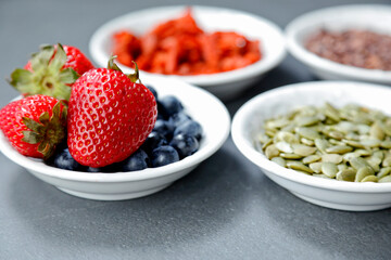 Bowl of fresh fruit. blackberries; strawberries, seeds on a bowl. Healthy breakfast. Vegetarian organic meal.