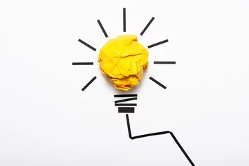 Foto op Plexiglas Inspiration concept crumpled color paper light bulb metaphor for good idea © spacezerocom