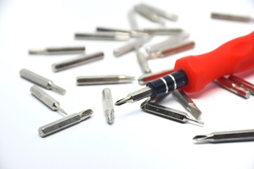 A set of small screwdrivers. metal screwdriver bits.Multi-bit repair tools kit set torx screwdrivers for gadgets isolated on a white background,
