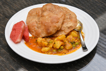Bedmi puri, Poori, methi paratha with aloo ki sabzi potato curry, top view of traditional Indian breakfast recipe in Jaipur, Rajasthan, India. Made with whole wheat and fenugreek leaves.