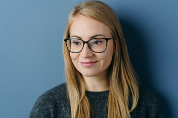 Young woman looking aside with a pleased smile