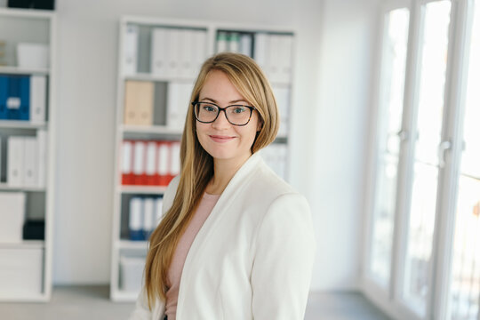 Smart friendly businesswoman posing in an office