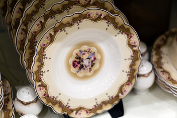 Luxury white ceramic plates on a table is the background selective focus and shallow depth of field
