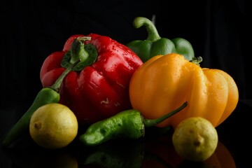 Fresh vegetables and fruits on black background