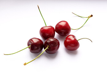 Obraz na płótnie Canvas Red ripe sweet cherry is on a white background. Healthy eating. Vitamins.