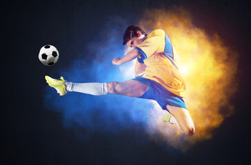 Fototapeta na wymiar Soccer player kicking ball in colorful smoke