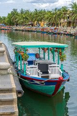 Wooden boat on the river water in old city of Hoi An, Vietnam