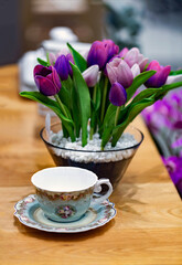 Mother's Day with a place for text. Copy space.
happy morning . life style shot with coffee and bouquet of pink tulips in a vase on a wooden table.